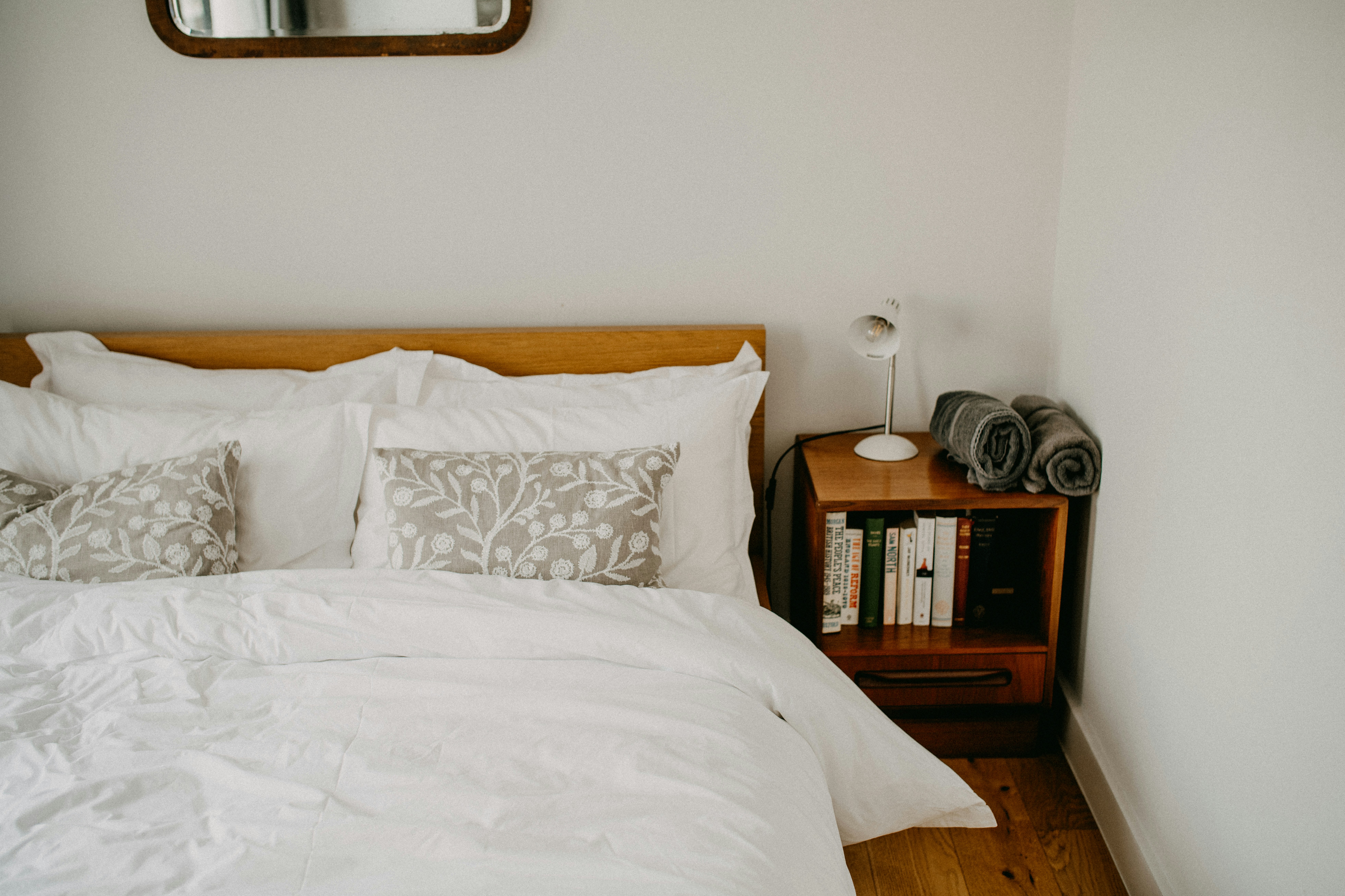 Cleaner tidying and cleaning a bedroom